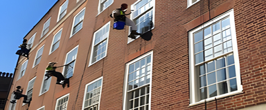 Rope access technicians working on a commercial building in London