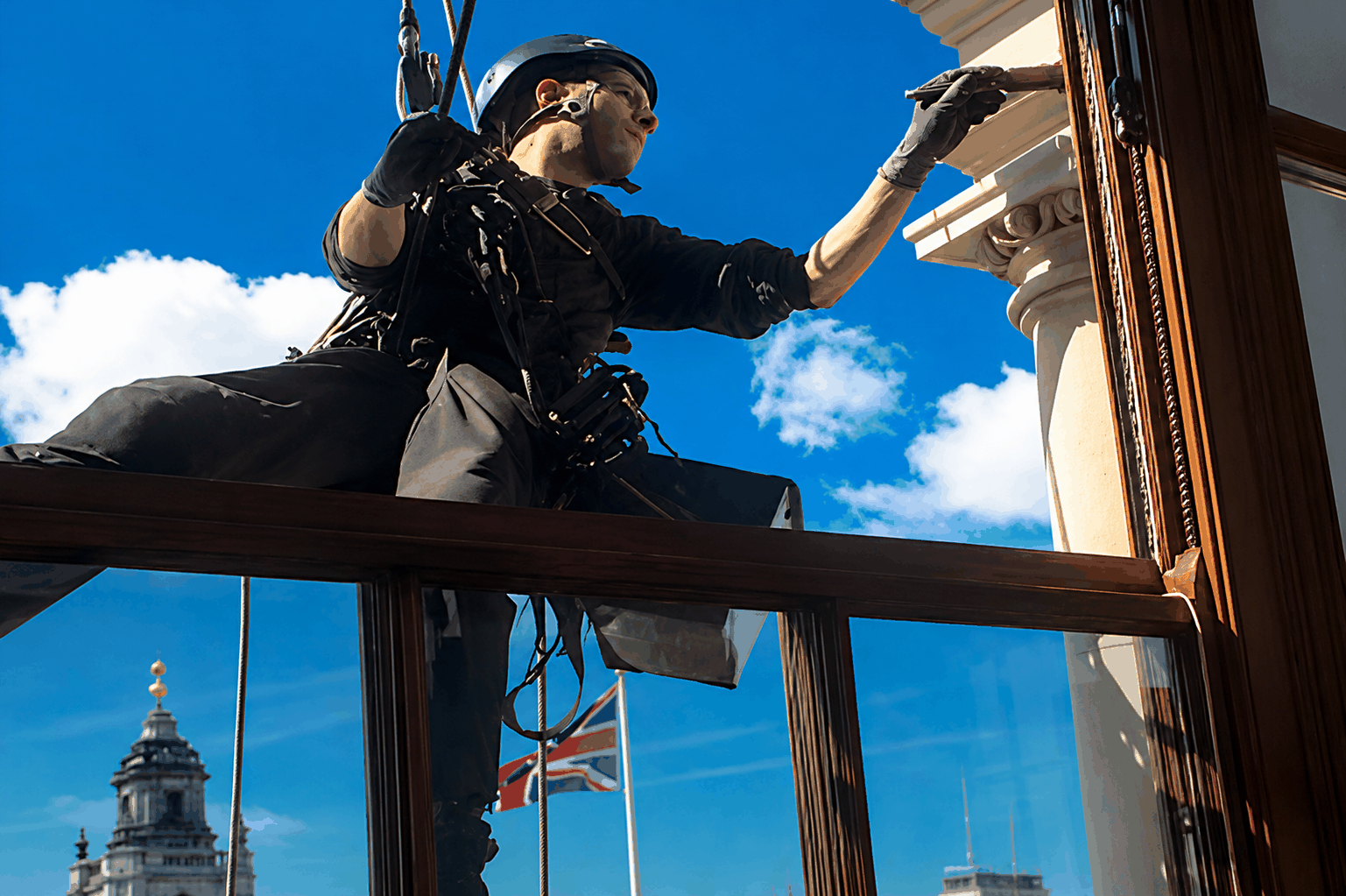 CCS rope access technician carrying out sash window restoration work during the HM Treasury London project