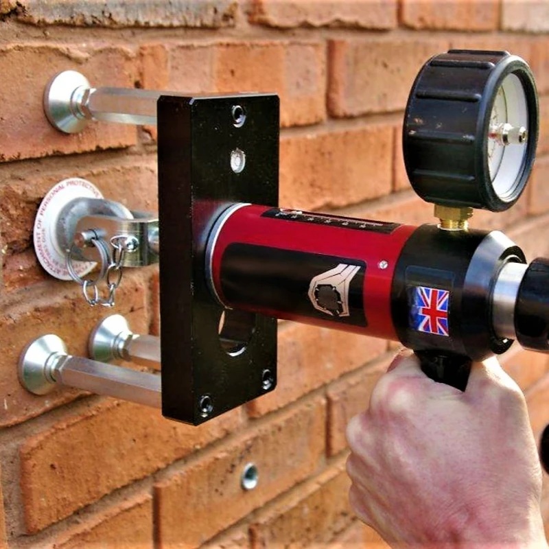 Eyebolt testing equipment fixed to a brick wall