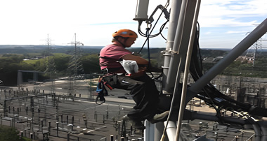 Rope access team conducting periodic inspections of a bridge suspension system