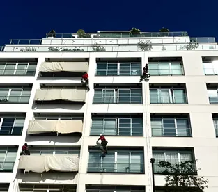 Skilled abseilers utilizing rope access techniques to provide painting services for tall structures, demonstrating their efficiency and precision.
