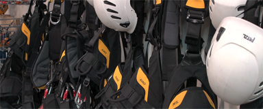 An image illustrating the inspection of personal protective equipment (PPE), emphasizing the importance of proper gear and safety measures in rope access operations.